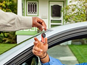 man lending the keys of his car to his son